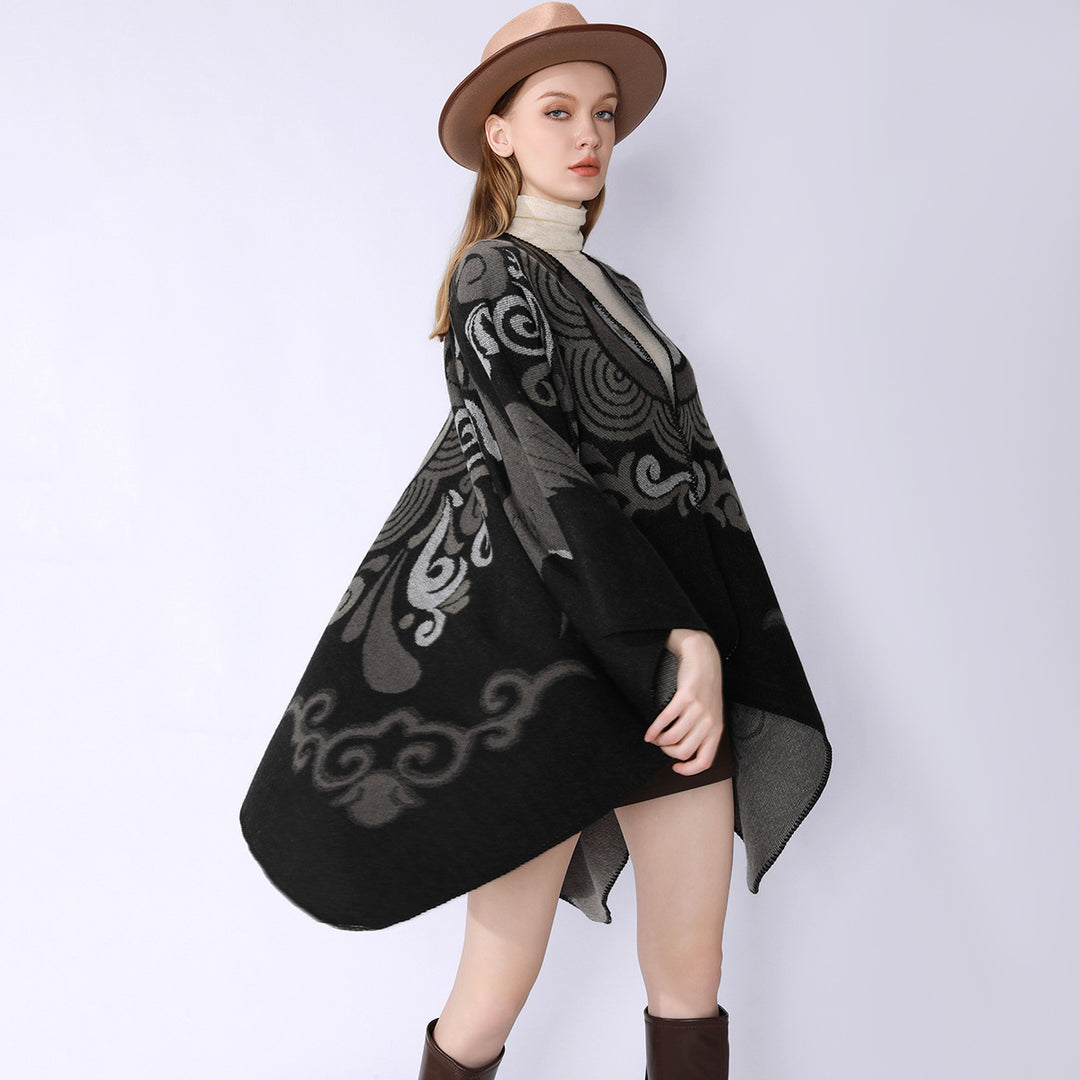 Women's wool blend cape with ornamental jacquard, asymmetrical tip and soft falling oversized drape.