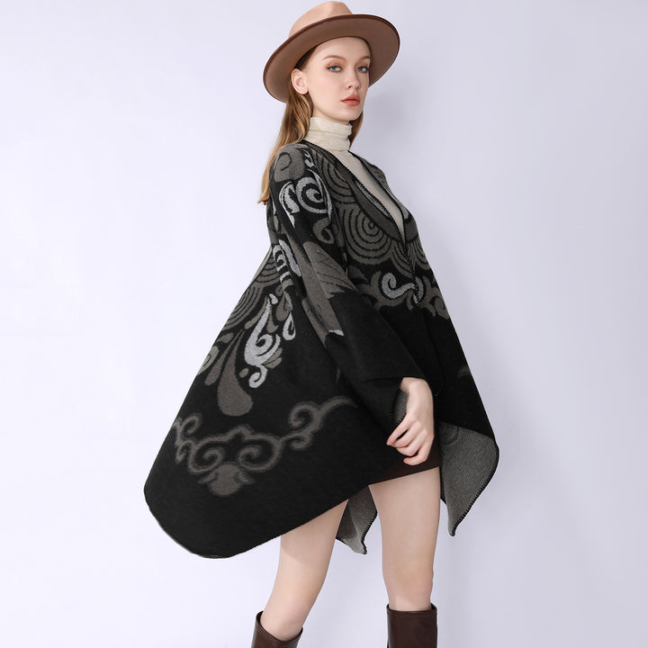 Women's wool blend cape with ornamental jacquard, asymmetrical tip and soft falling oversized drape.