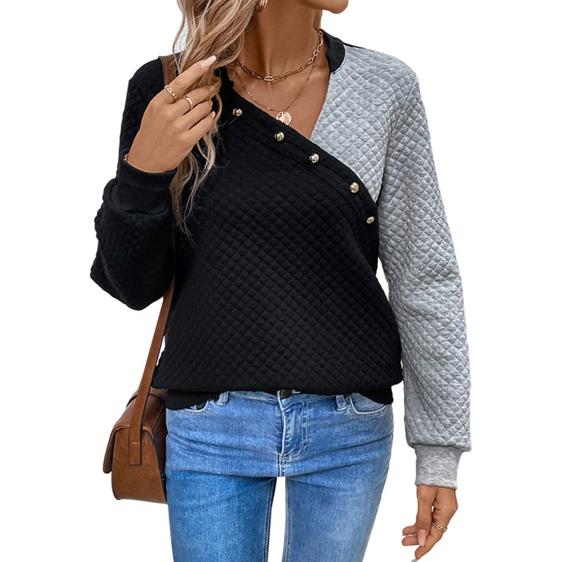 Women’s quilted sweatshirt with asymmetric lapel, decorative press buttons, and color block sleeves Mune Fashion