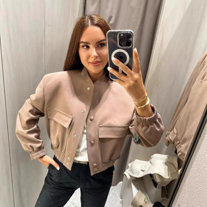 Women's short bomber jacket with stand-up collar, snap button placket, patch pockets, and elastic hem Mune Fashion