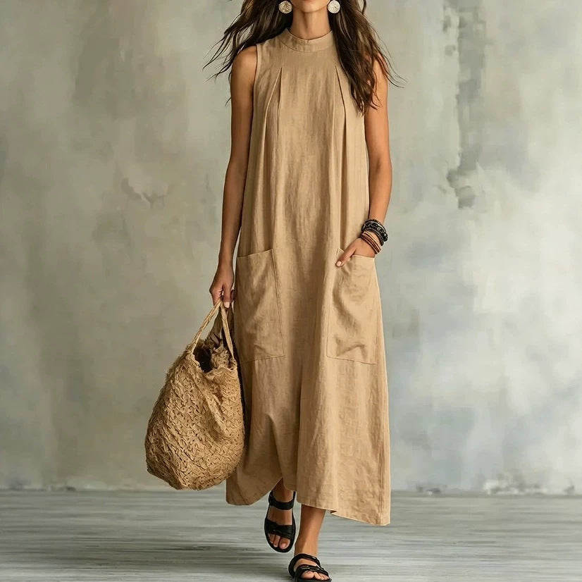 Women’s sleeveless linen maxi dress with standing collar, pleats at the chest, and piled pockets Mune Fashion