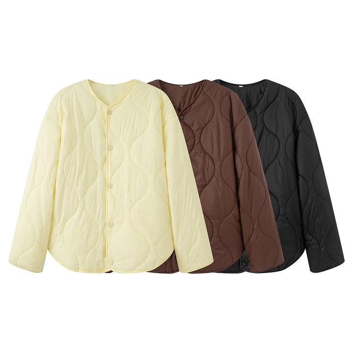 Women's quilted transition jacket with round neckline, snap button closure, and curved hem Mune Fashion