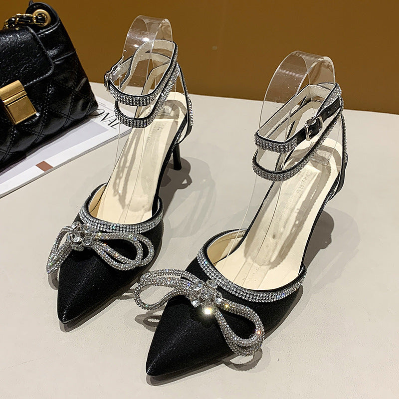 Women's pointed strap pumps with sparkling rhinestone bow appliqué and adjustable ankle strap Mune Fashion