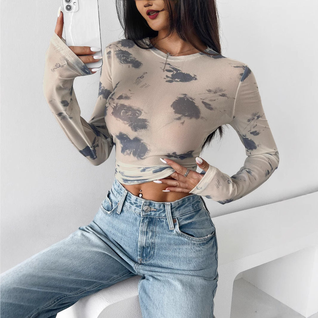 Women's form-fitting tailored crop mesh top with round neck, extended sleeves, thumb holes, and subtle tie-dye pattern Mune Fashion