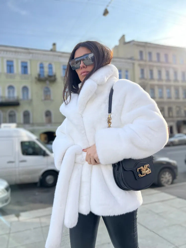 Ladies short coat made of luxurious faux fur with a waist belt and high shawl collar Mune Fashion