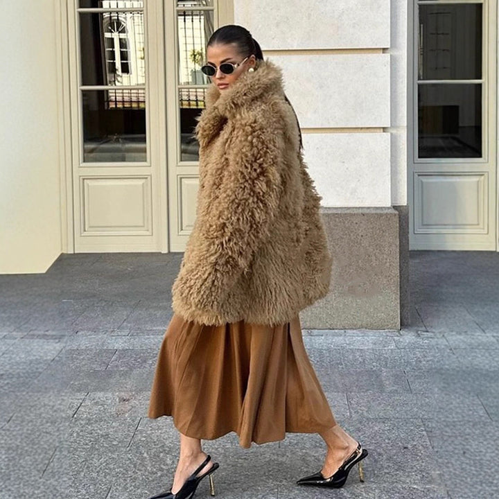 Women’s short coat made of voluminous bouclé faux fur with wrap and waist belt Mune Fashion