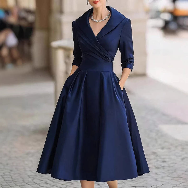 Women's elegant midi dress with wrap top, three-quarter sleeves, and side pockets Mune Fashion