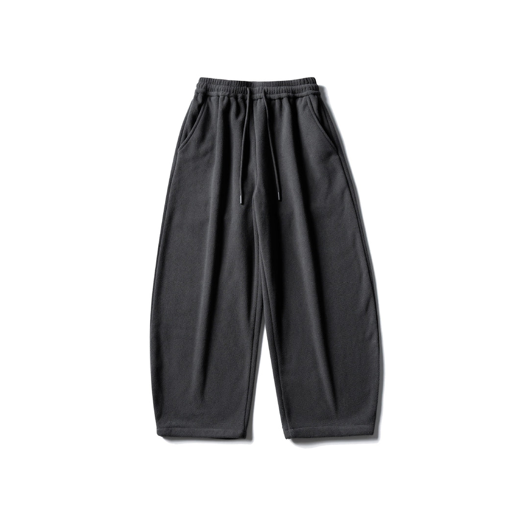 Unisex fleece jogging pants with elastic drawstring waistband, side pockets and tapered leg Mune Fashion