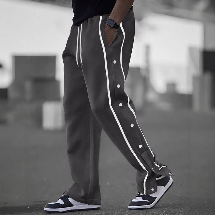 Men's casual training pants with side snap button placket, elastic waistband and contrasting piping Mune Fashion