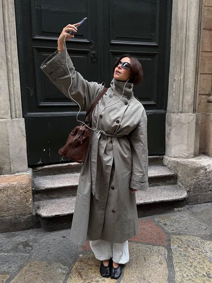 Women’s maxi trench coat with high stand-up collar, double-breasted button placket & waist belt Mune Fashion