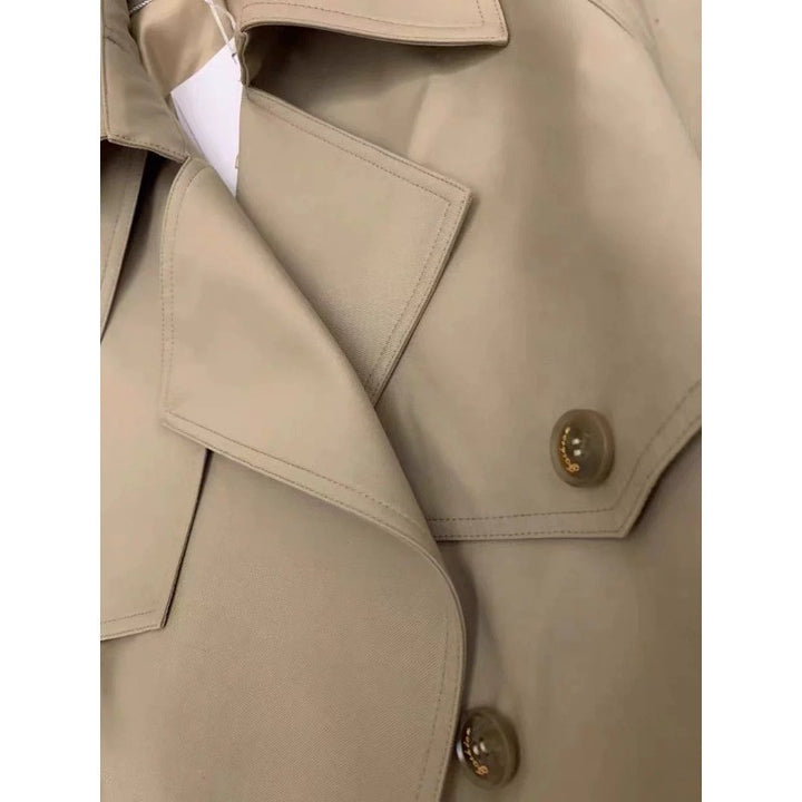 Women's elegant midi trench coat with oversized shoulder flap, gathered sleeves, and waist-defining tie belt Mune Fashion