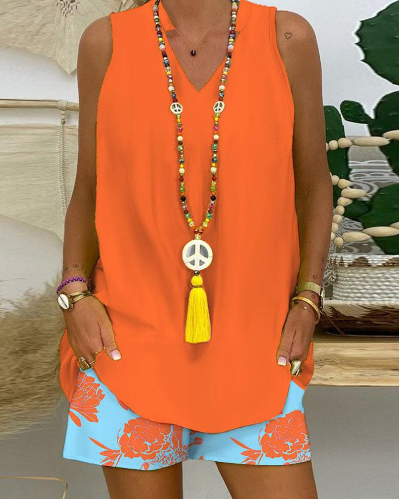 Women's sleeveless V-neck long top with curved hem and side insertion pockets Mune Fashion