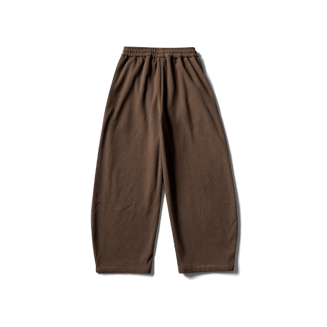 Unisex fleece jogging pants with elastic drawstring waistband, side pockets and tapered leg Mune Fashion
