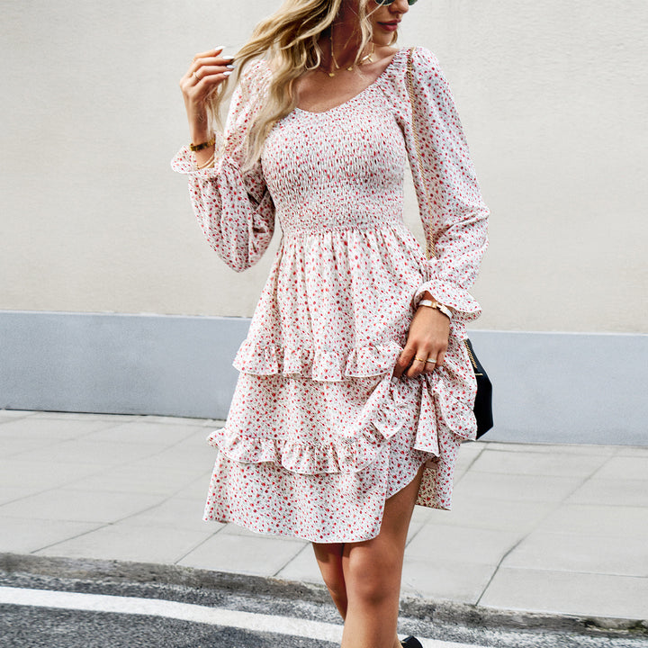 Women’s smocked Carmen mini dress with puff sleeves, tailored smocked bodice, and asymmetric ruffle hem Mune Fashion