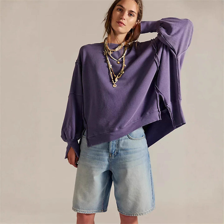 Women's oversized sweatshirt with balloon sleeves, open seam stitches, and side slits Mune Fashion