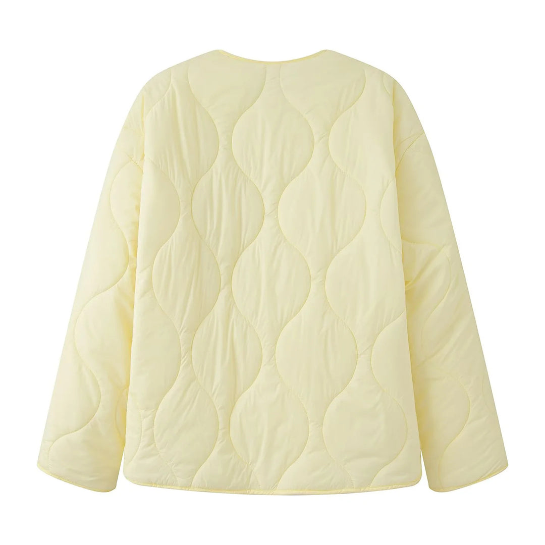 Women's quilted transition jacket with round neckline, snap button closure, and curved hem Mune Fashion