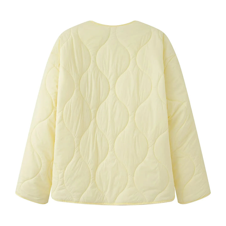 Women's quilted transition jacket with round neckline, snap button closure, and curved hem Mune Fashion