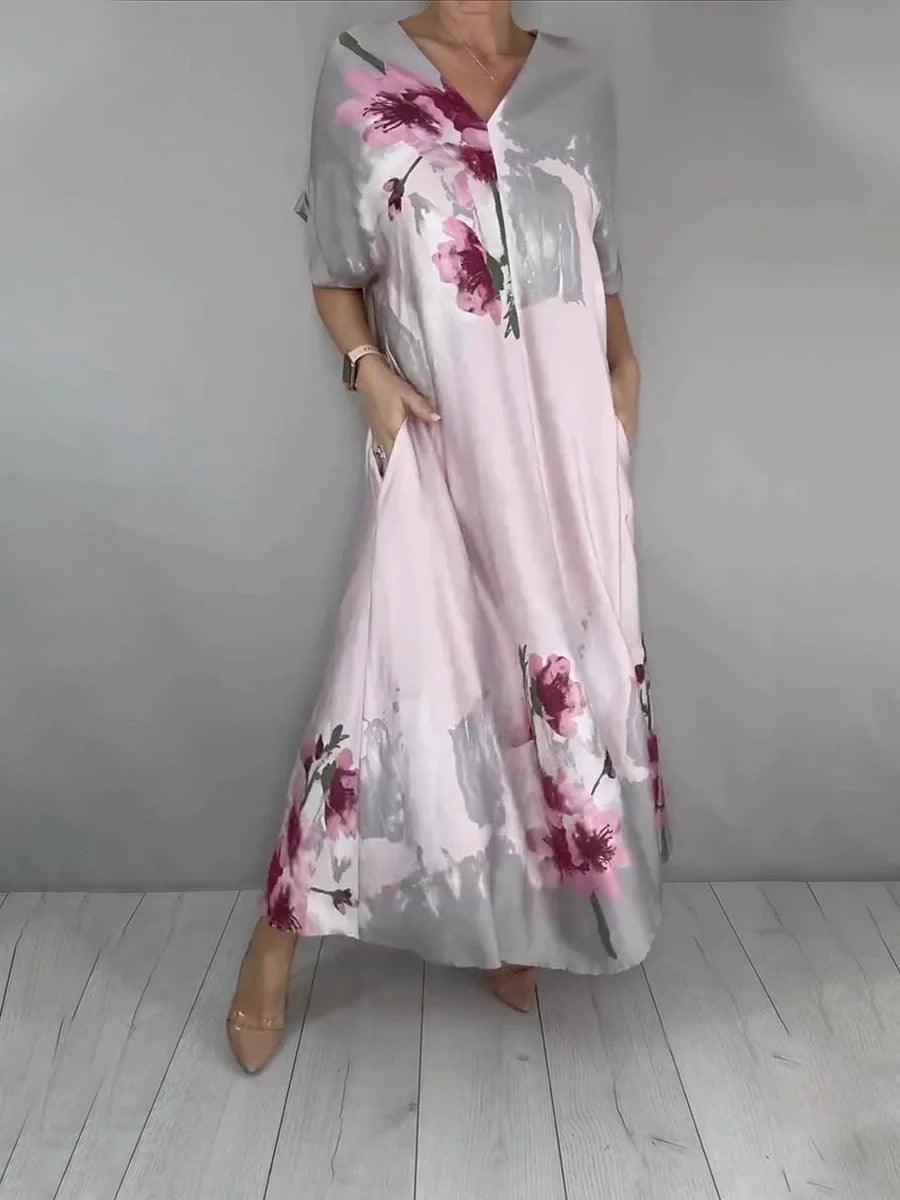 Women's maxi dress with a flowing fall, V-neck, side pockets, and floral watercolor look Mune Fashion