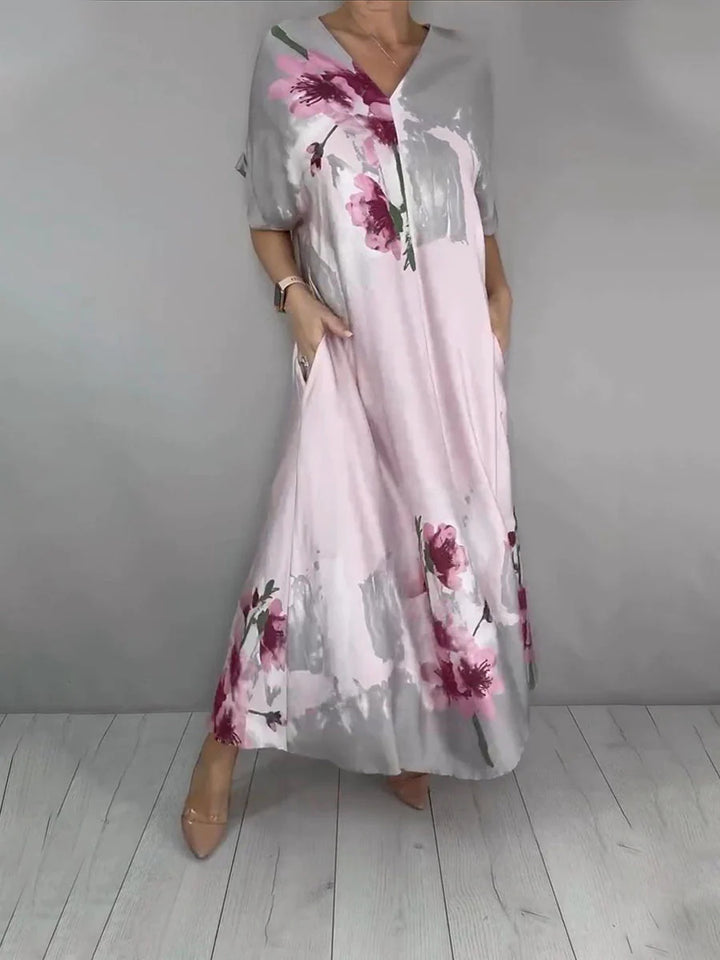Women's maxi dress with a flowing fall, V-neck, side pockets, and floral watercolor look Mune Fashion
