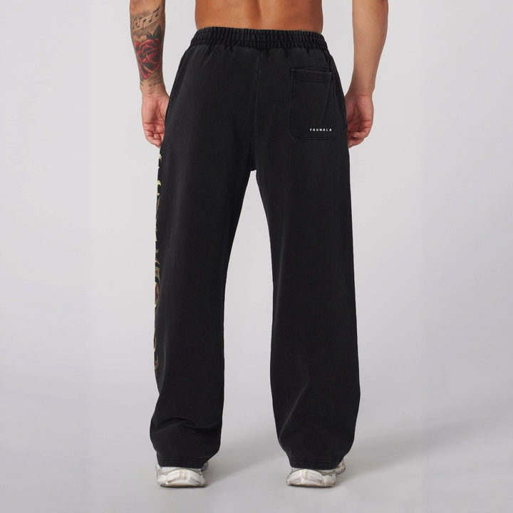 Men's baggy joggers with elastic waistband, side pockets and detailed skull and rose motif Mune Fashion