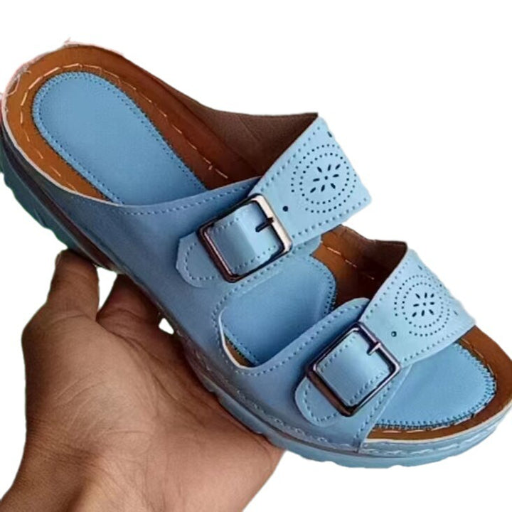 Women's double-strap slide with laser perforation, adjustable metal buckles, and padded wedge footbed Mune Fashion