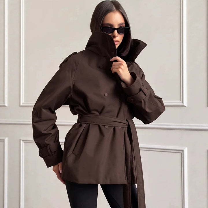 Women Short Technical Trench with High Collar Flap, Double Press Button Placket and Tailoring Tie Belt Mune Fashion
