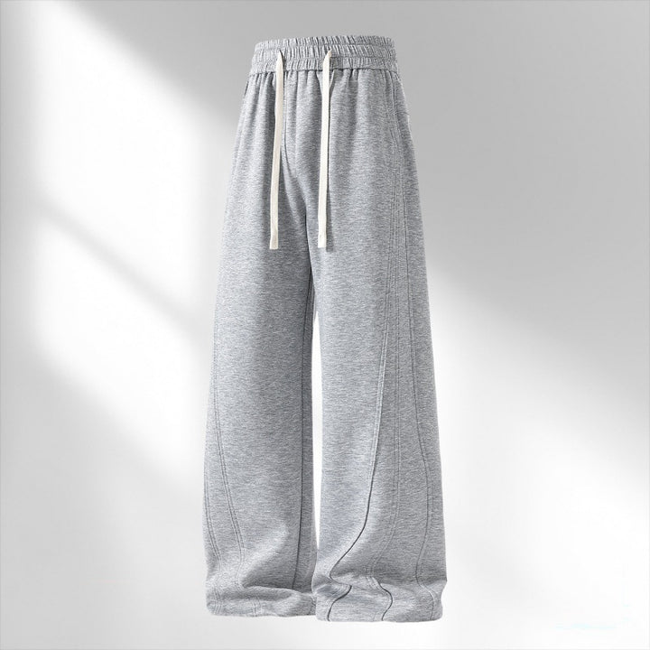 Women's wide lounge sweatpants with elastic drawstring waistband and decorative side seam details Mune Fashion