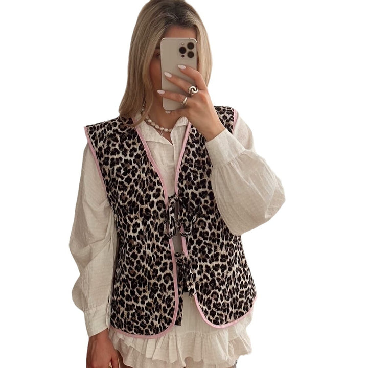 Ladies nan lightweight quilted reversible vest with leopard print, contrast piping, and double bow closure Mune Fashion