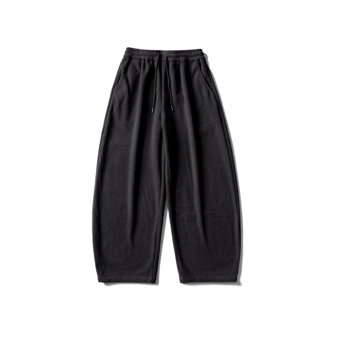 Unisex fleece jogging pants with elastic drawstring waistband, side pockets and tapered leg Mune Fashion