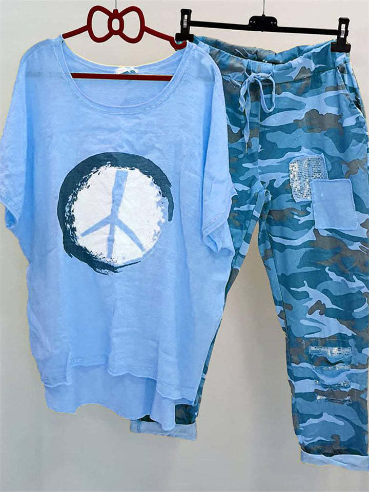 Women’s casual leisure two-piece with wide-cut linen look shirt, peace symbol and camouflage jog pants with patch details Mune Fashion