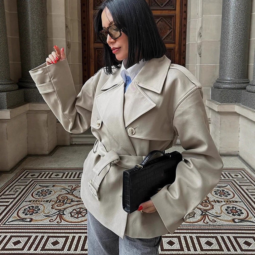 Women's short trench-style jacket with a tailored tie belt and wide sleeves Mune Fashion
