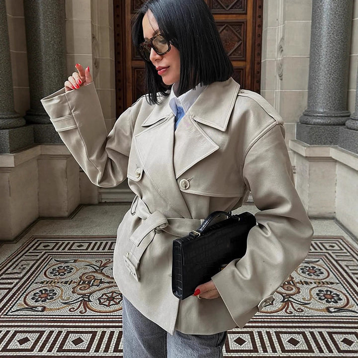 Women's short trench-style jacket with a tailored tie belt and wide sleeves Mune Fashion