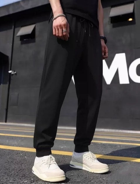 Men's sporty jogging pants with elastic waistband and practical side pockets Mune Fashion