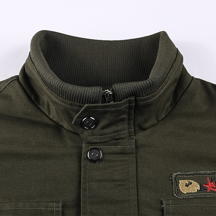 Men's rugged field jacket with multiple pockets, quilted inner lining, and ribbed cuffs.