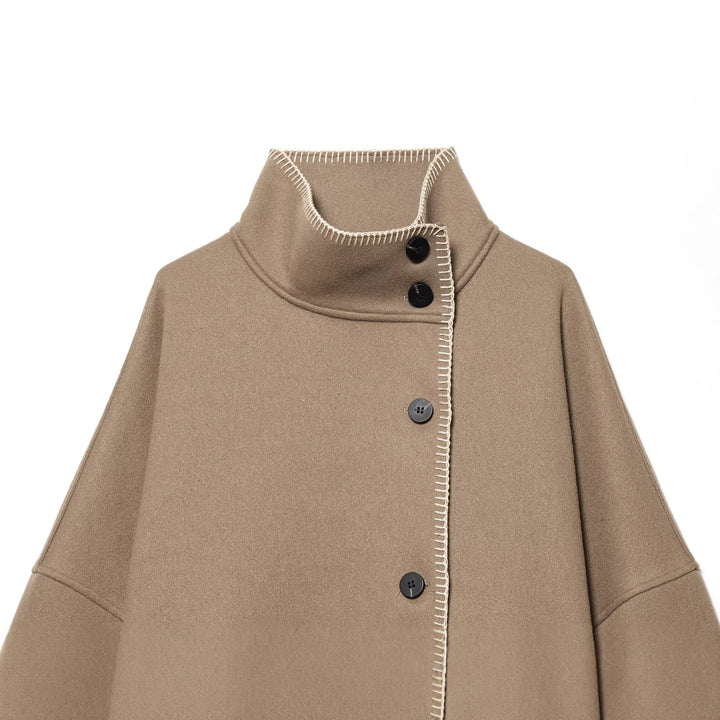 Women's cozy wool cape with high stand-up collar, asymmetrical button placket and decorative seam Mune Fashion