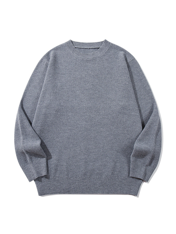 Unisex chunky knit round neck sweater with textured purl stitch and ribbed cuffs