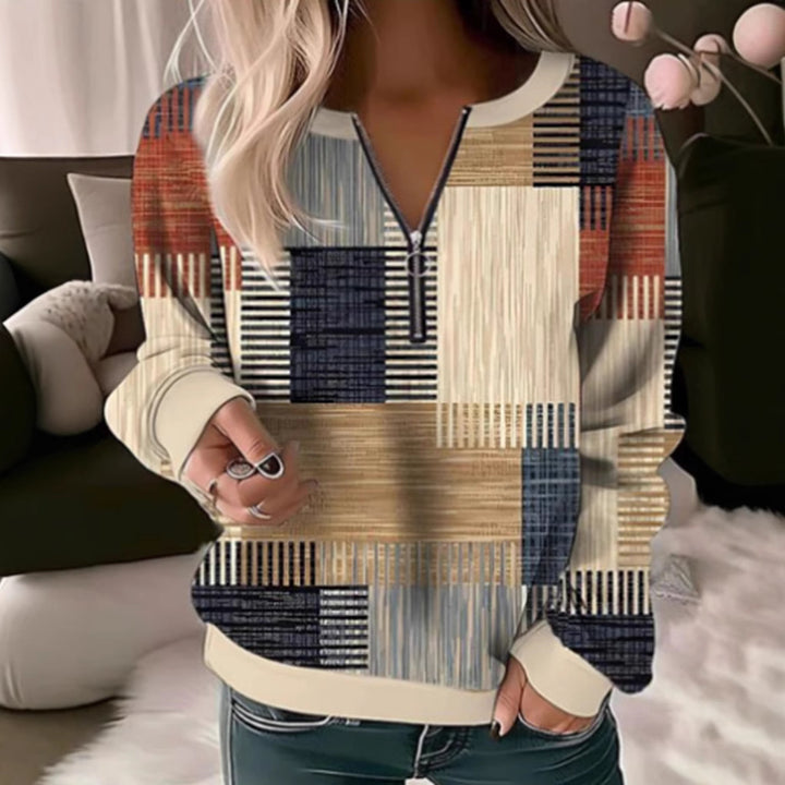 Women's cozy sweater with short zip, graphic patchwork pattern, extended sleeve cuffs, and ribbed hem Mune Fashion