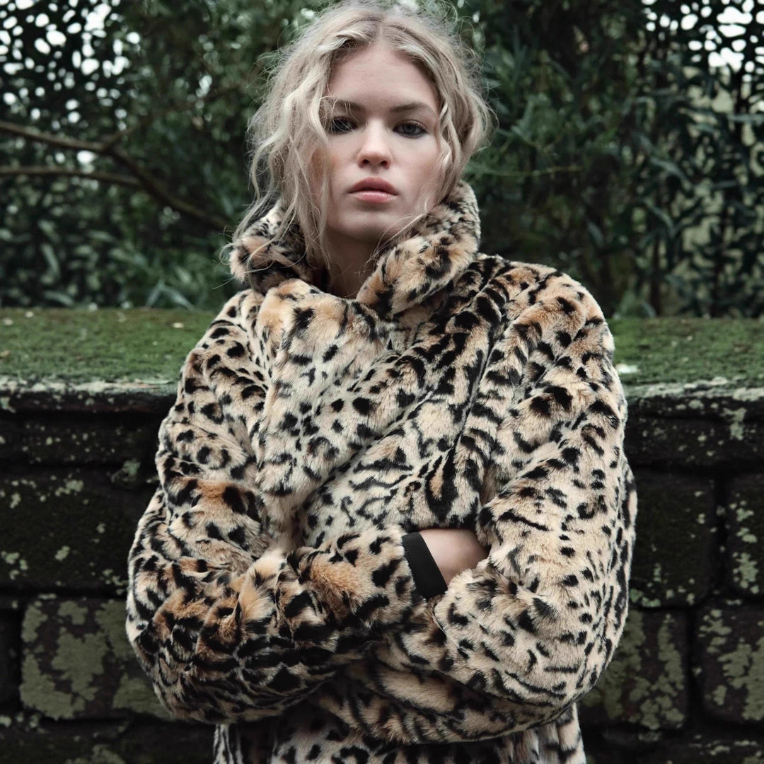 Women's faux fur coat in oversized cut with lapel collar, tie belt and pockets Mune Fashion
