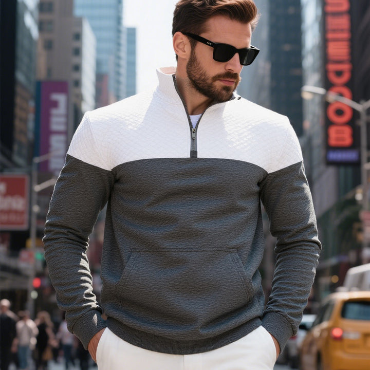 Men's color block half zip sweatshirt with quilted chest area, kangaroo pocket, and elastic cuffs Mune Fashion