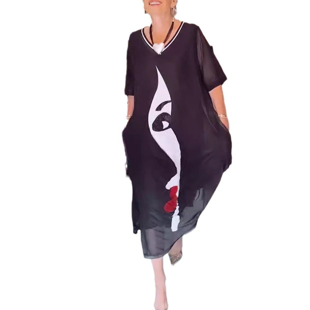 Women's airy chiffon maxi dress with graphic face print, V-neck and side pockets Mune Fashion