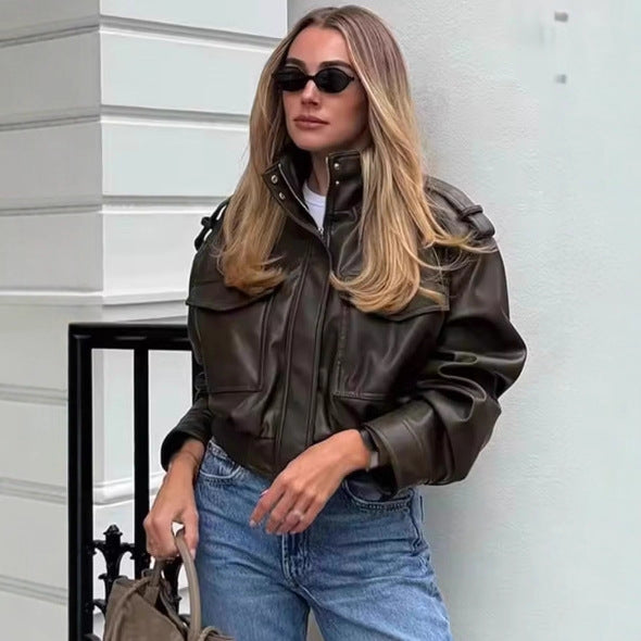 Women's short-cut military-inspired faux leather jacket with high stand collar, flap pockets, shoulder epaulets, and ribbed cuff Mune Fashion