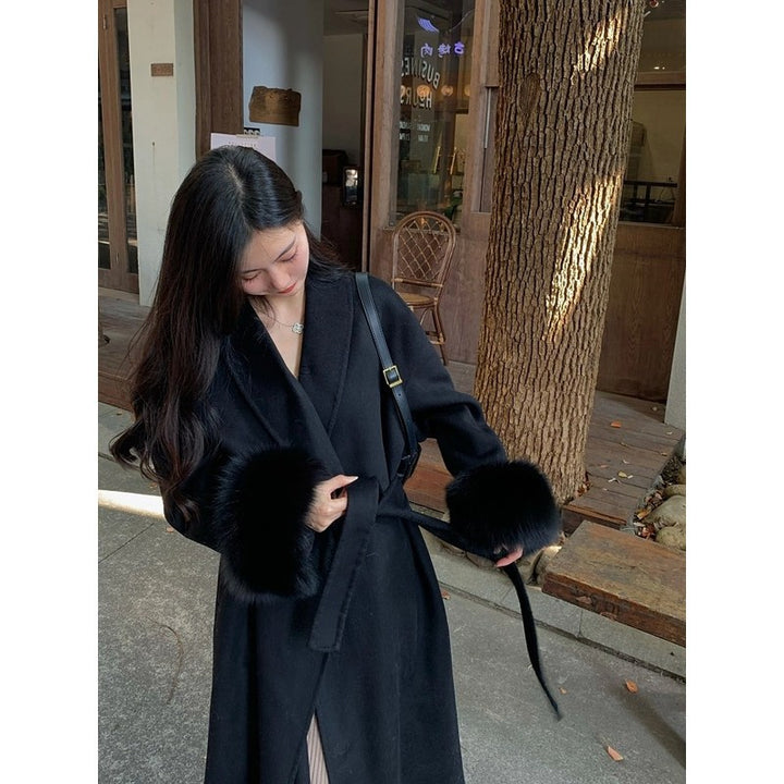 Women's Long Wool Blend Coat with Waist Belt and Voluminous Fur Trim at Sleeve Ends Mune Fashion