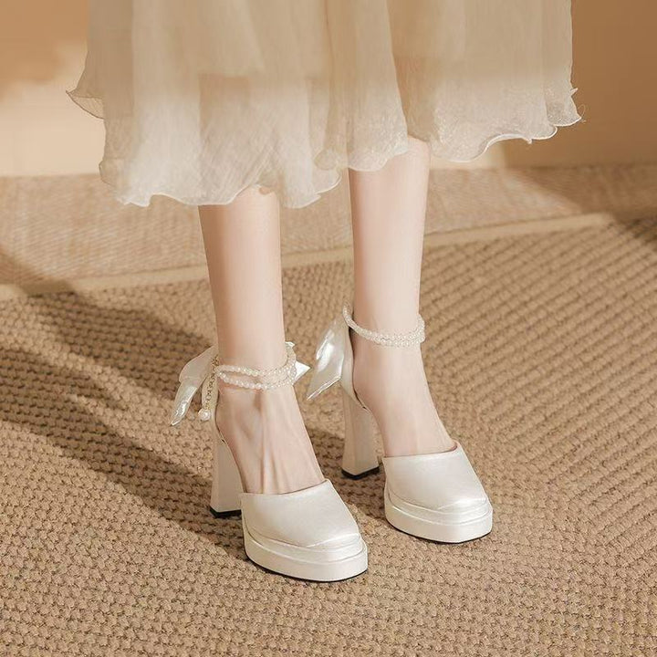Ladies' satin platform pumps with decorative bow and adjustable ankle strap Mune Fashion