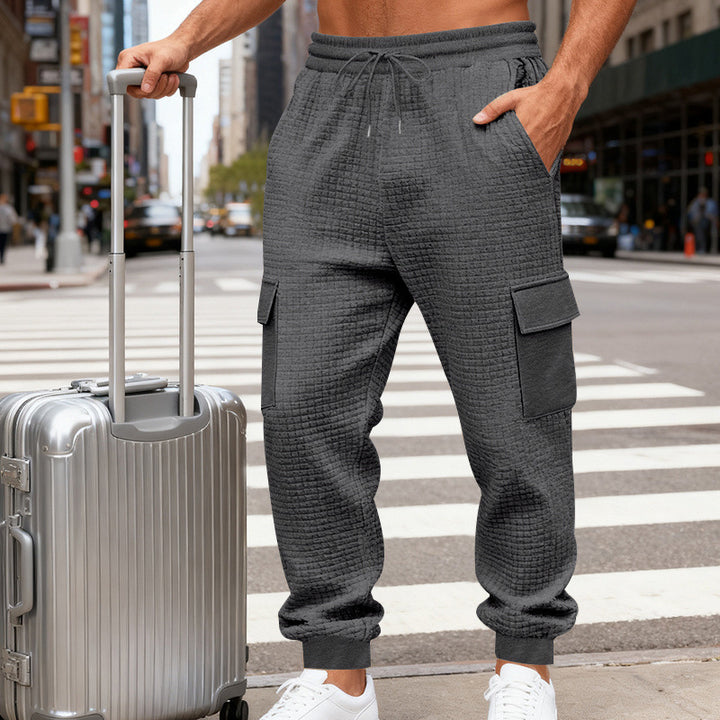 Men's cargo joggers with distinctive waffle texture, elastic waistband, and large flap pockets Mune Fashion