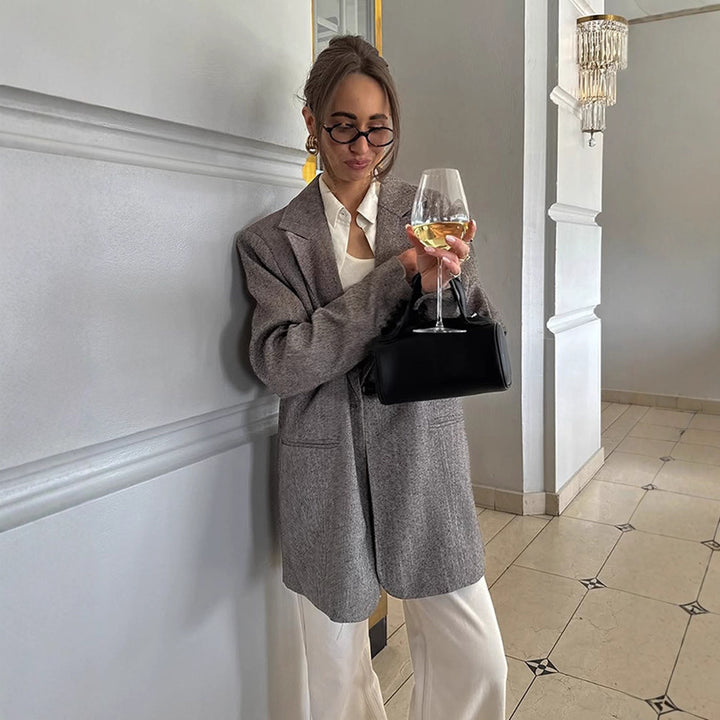 Women's long oversized wool blend coat with single-breasted button placket, notched lapels, and side pockets Mune Fashion