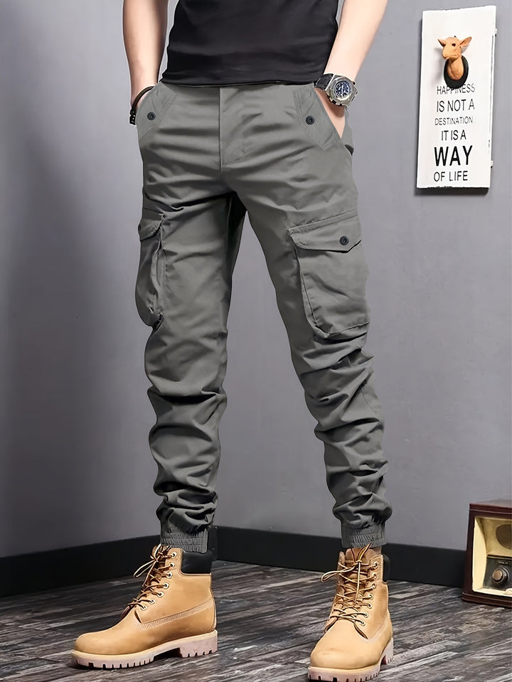 Men's cargo jogger pants with elastic waistband, drawstring, and multifunctional pockets.