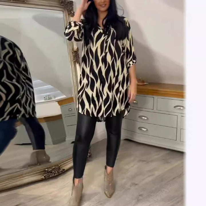 Women's oversized tunic blouse with organic leaf print, V-neckline, half button placket, and rounded hem Mune Fashion