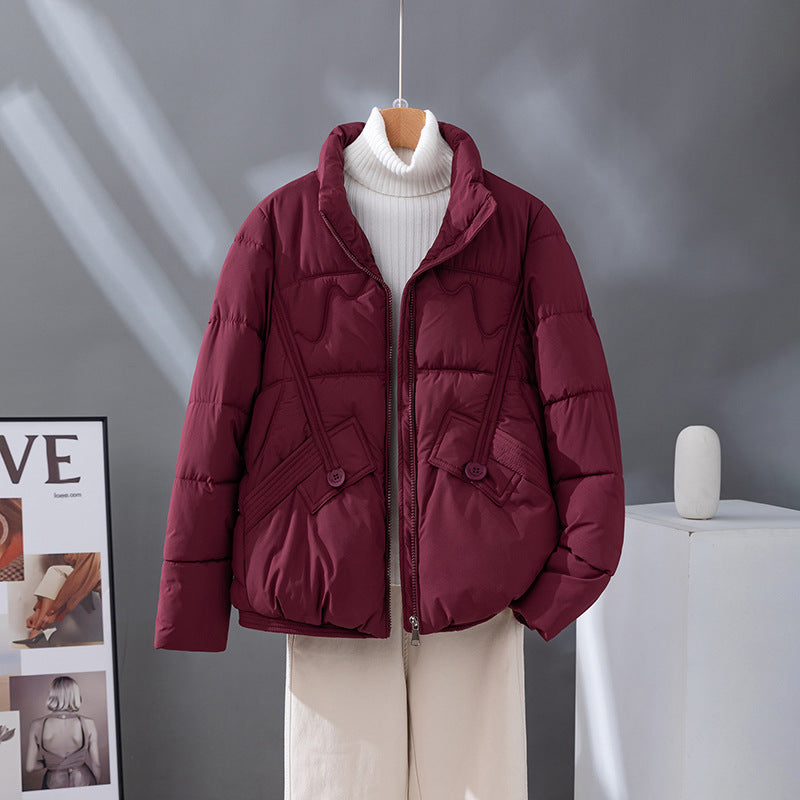 Women's nan short quilted jacket with high collar trim, diagonally placed decorative seams and flap pockets Mune Fashion