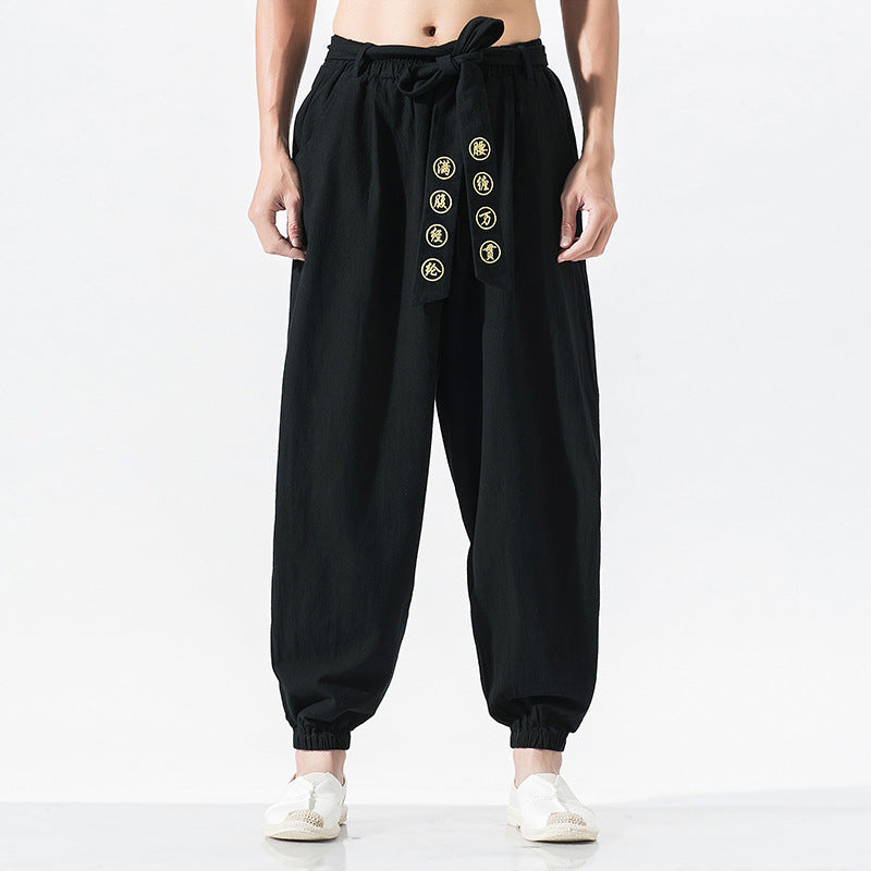 Women's wide linen trousers with drawstring waistband, binding detail, and elastic ankle cuffs Mune Fashion