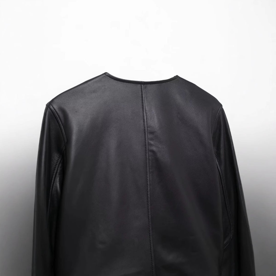 Women's cropped faux leather jacket with round neckline, double-breasted button placket and patch pockets Mune Fashion
